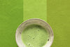 Japanese green tea matcha latte on striped green background