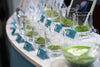 samples of matcha in a trade show display. A matcha latte sits in the foreground.