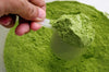 Premium custom matcha mix being scooped into a small cup